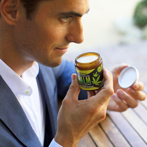 Man smelling the Naked Armor Hemp Aftershave Balm