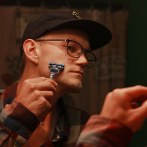 Man shaving with the Naked Armor American Razor Powdered Steel