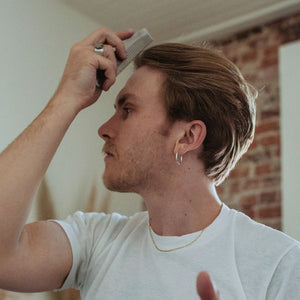 Man combing his hair with the Ezra Arthur No.1827 Pocket Comb Malbec