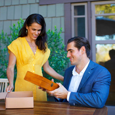 Man receiving a Naked Armor Straight Razor Kit as a gift from a woman