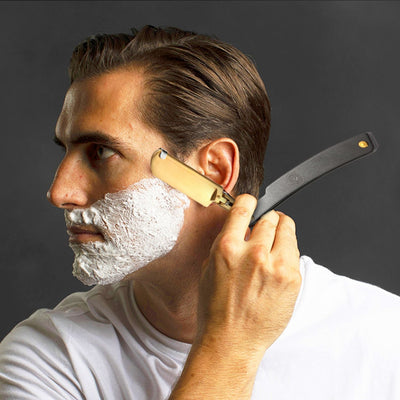 Man shaving with the black Lucan Shavette Straight Razor