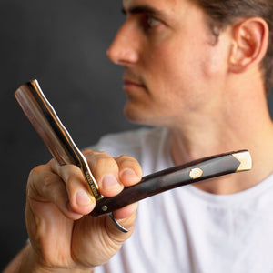 Man holding the Naked Armor King Arthur Gold Straight Razor 7/8" Ebony Japanese Stainless Steel