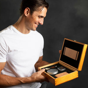 Man smiling while holding the Naked Armor Solomon 7 Piece Straight Razor Kit 7/8 Brown
