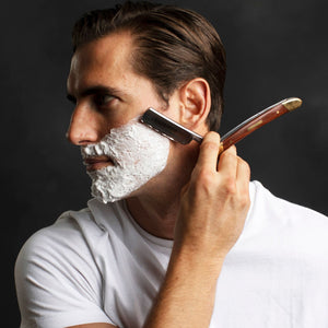 Man shaving with the Naked Armor Solomon Straight Razor 7/8" Brown Algum Wood Japanese Steel