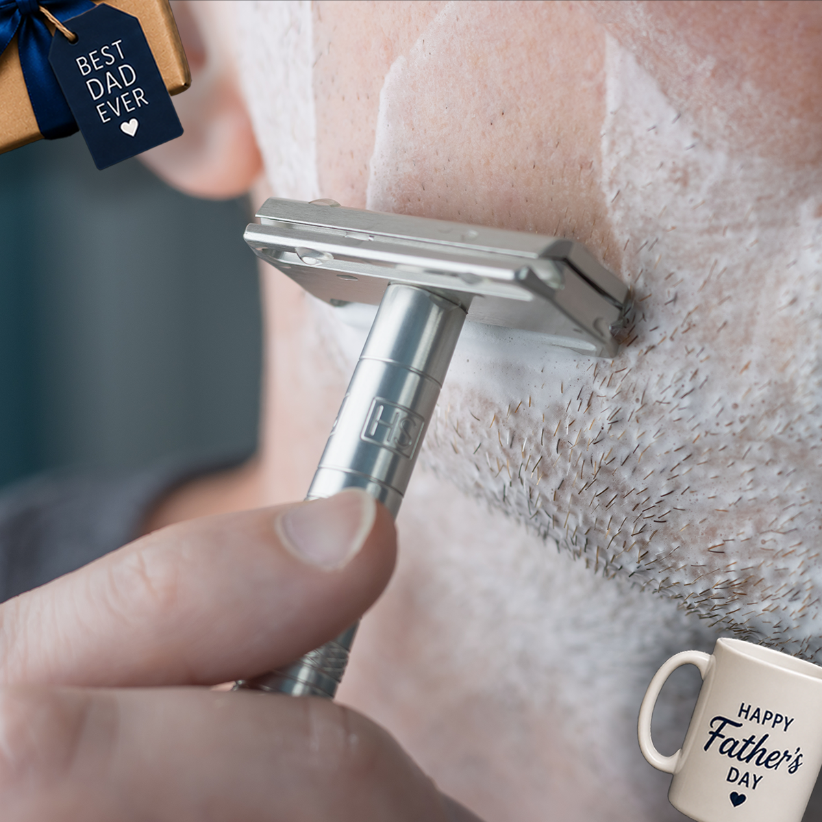 Man shaving with a Henson AL13 Aluminum Safety Razor next to Father's Day gifts.