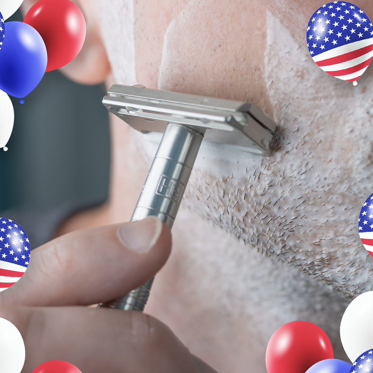 Close-up of a man with a lather on his face and shaving his beard with a silver Henson AL13 safety razor.