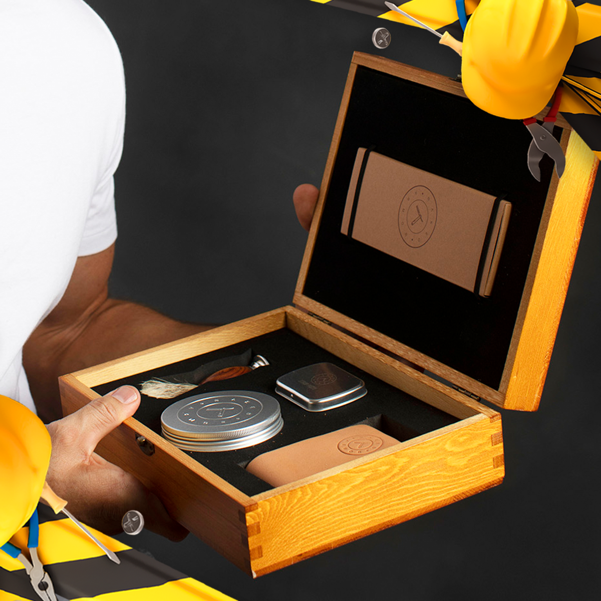 Open wooden presentation box displaying a Naked Armor straight razor kit with shaving brush, soap, and leather strop, featuring Labor Day accents.